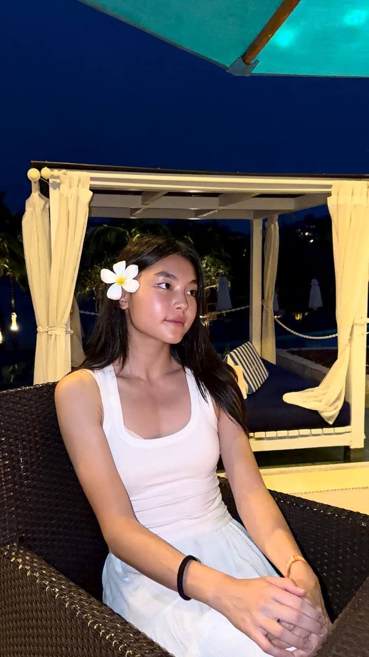 Portrait of Zhasmin with a white flower in her hair, taken in the evening
